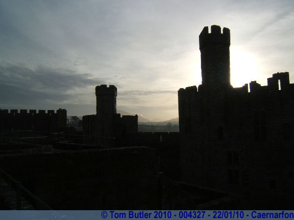 Photo ID: 004327, The sun starts to burn through the morning mists behind Caernarfon castle, Caernarfon, Wales