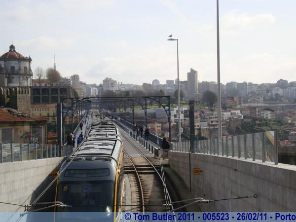Photo ID: 005523, A metro comes off of the top deck of the Ponte de Dom Luis I and descends into its tunnel, Porto, Portugal